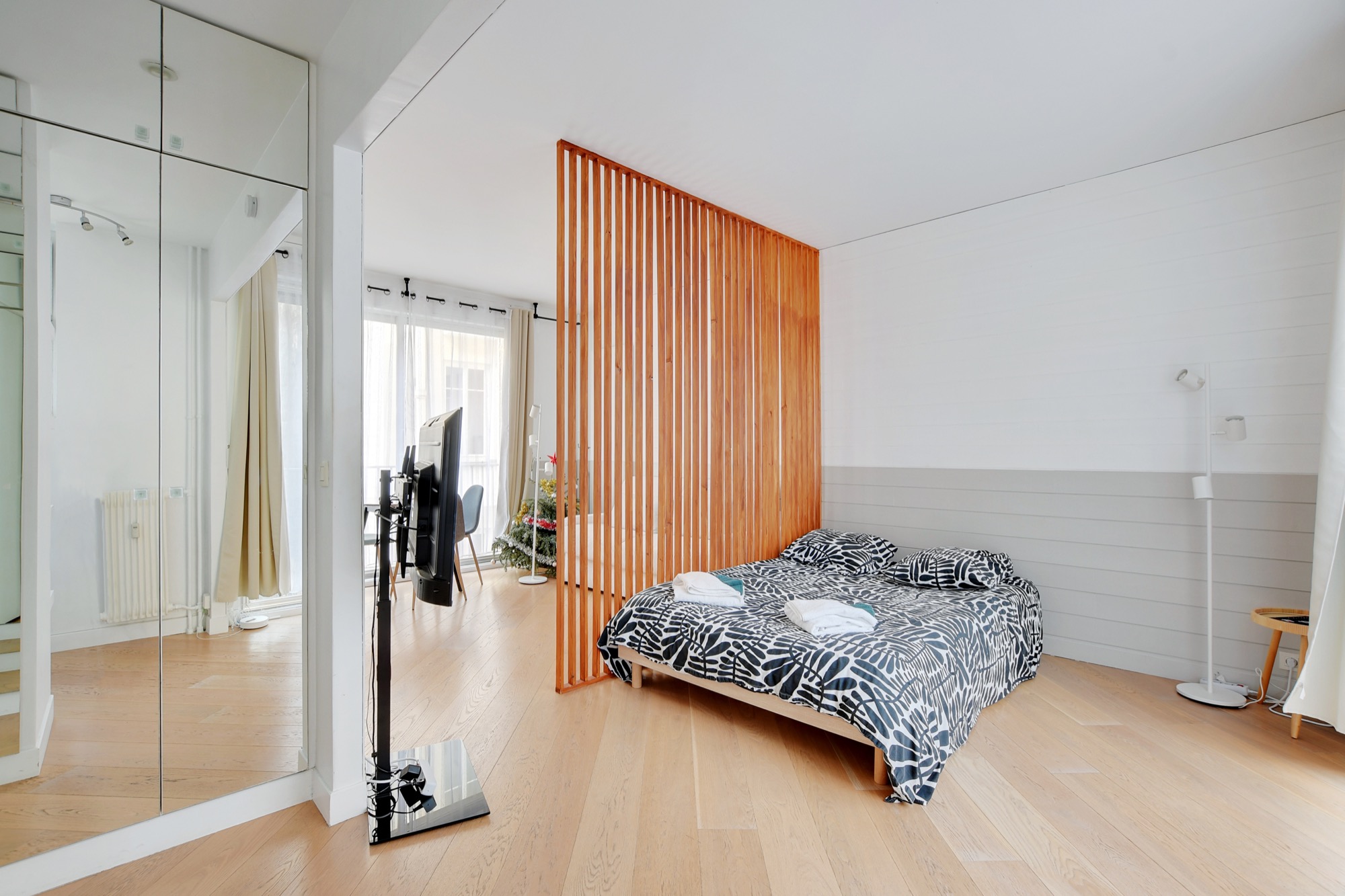 Bedroom behind wood slat divider